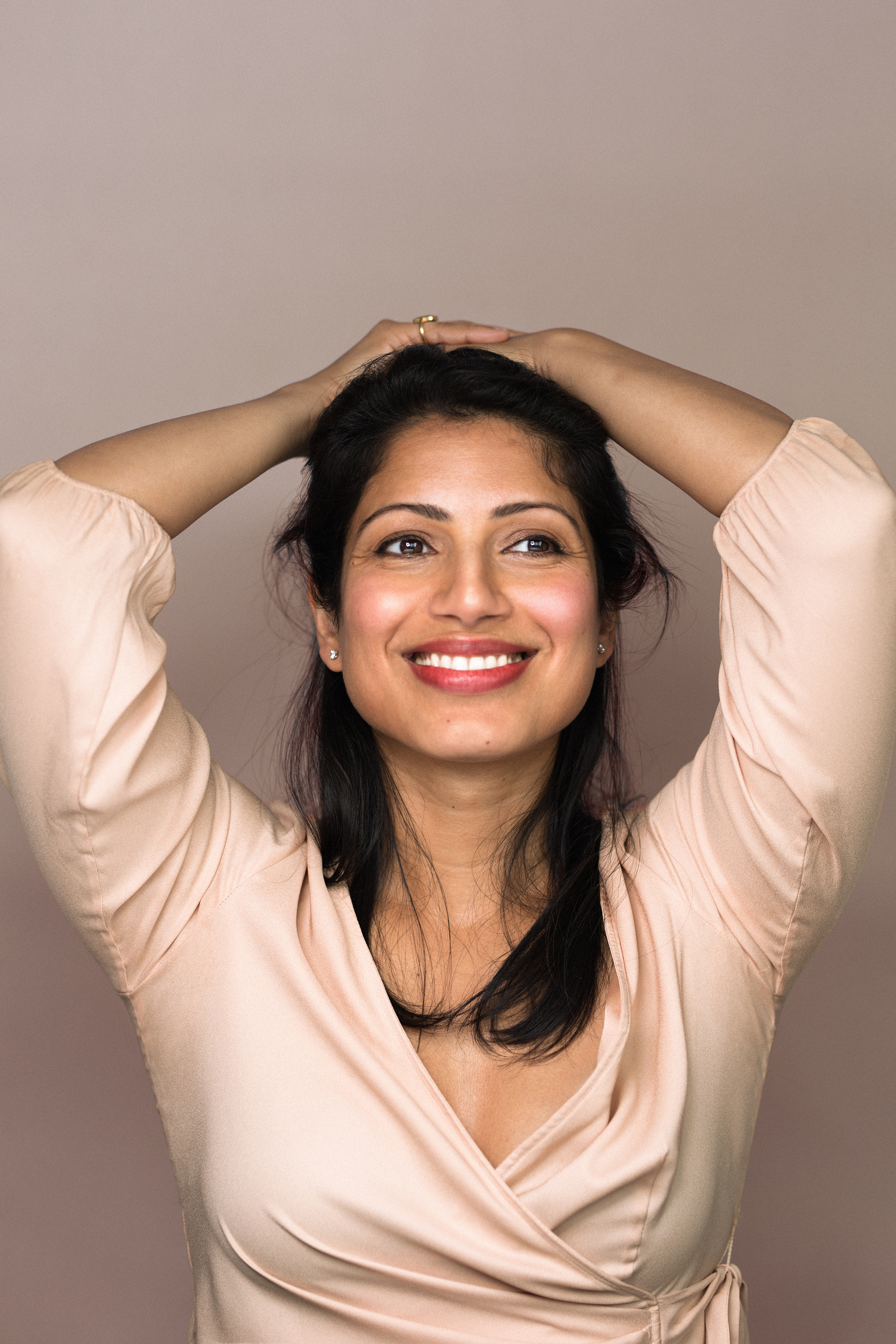 Richa Rudola smiling in a peach shirt